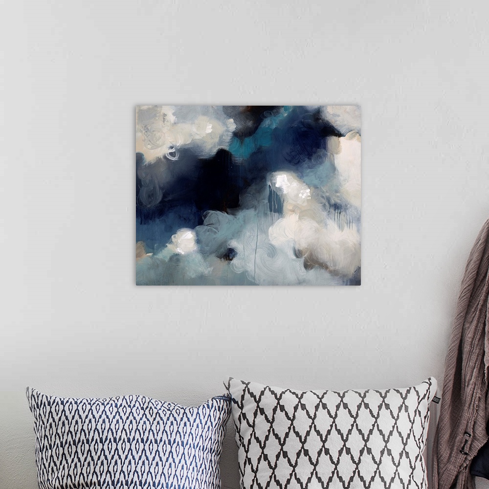 A bohemian room featuring Abstract painting of what almost looks like fluffy white clouds in an aggressive dark sky.