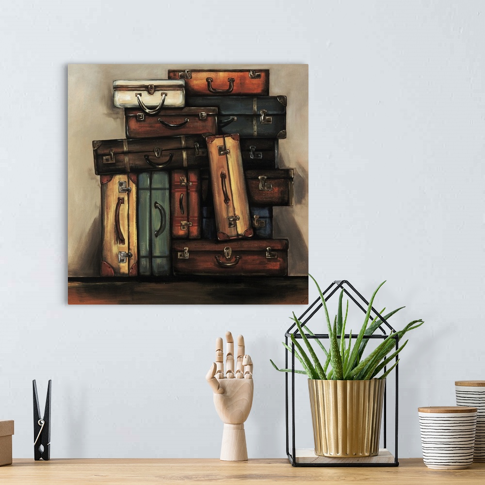 A bohemian room featuring Painting of a an assortment of multicolored vintage suitcases stacked together in front of a neut...