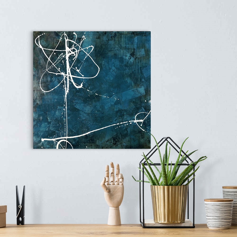 A bohemian room featuring Contemporary abstract painting using thin white flowing lines against a dark blue background.