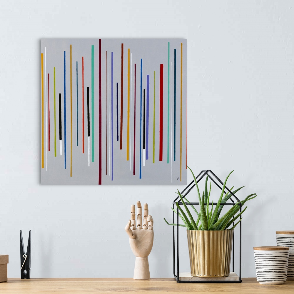 A bohemian room featuring Square abstract painting with thin, colorful, vertical lines in different lengths going across th...
