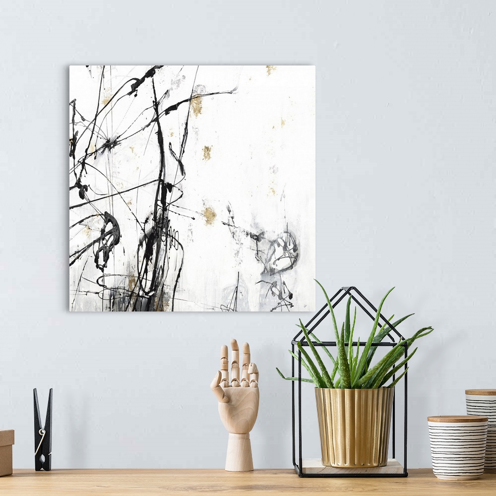 A bohemian room featuring Square abstract painting in white, gray, black, and gold with thin lines sporadically on top of t...