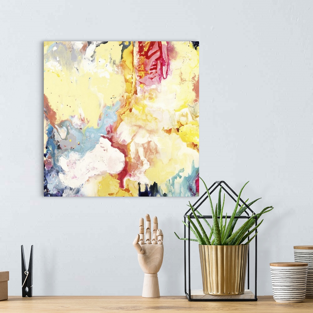 A bohemian room featuring Square abstract painting of vibrant colors in yellow, blue and red.