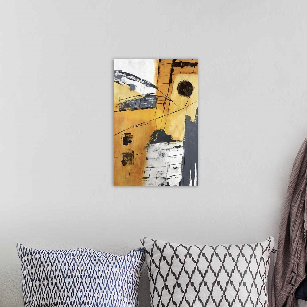 A bohemian room featuring Abstract painting in colors of yellow, gray and orange.