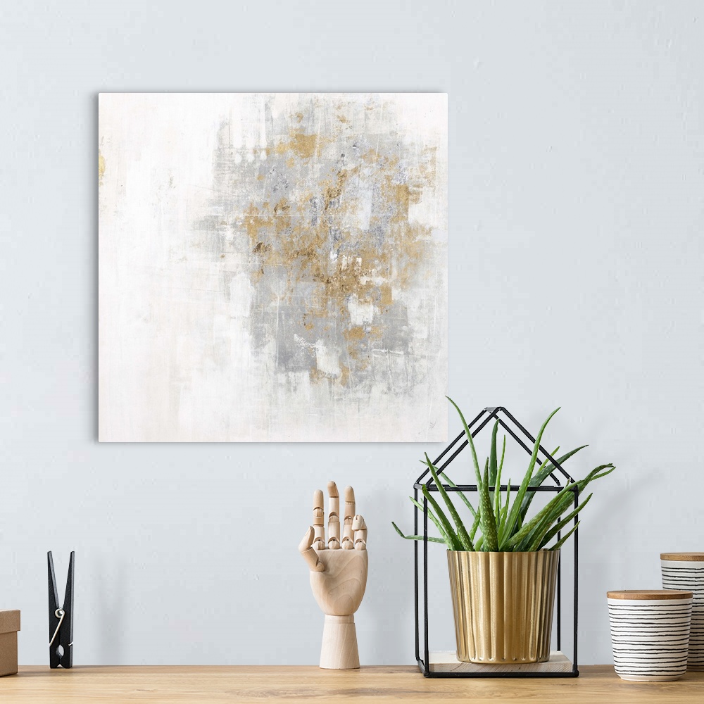 A bohemian room featuring Square abstract art with a cool toned silver and white background and metallic gold on top.