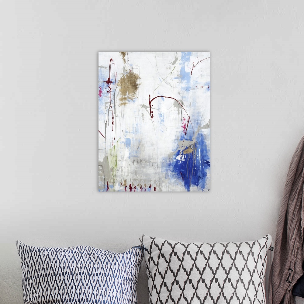 A bohemian room featuring Vertical abstract painting in gold and blue with textured drips of paint.