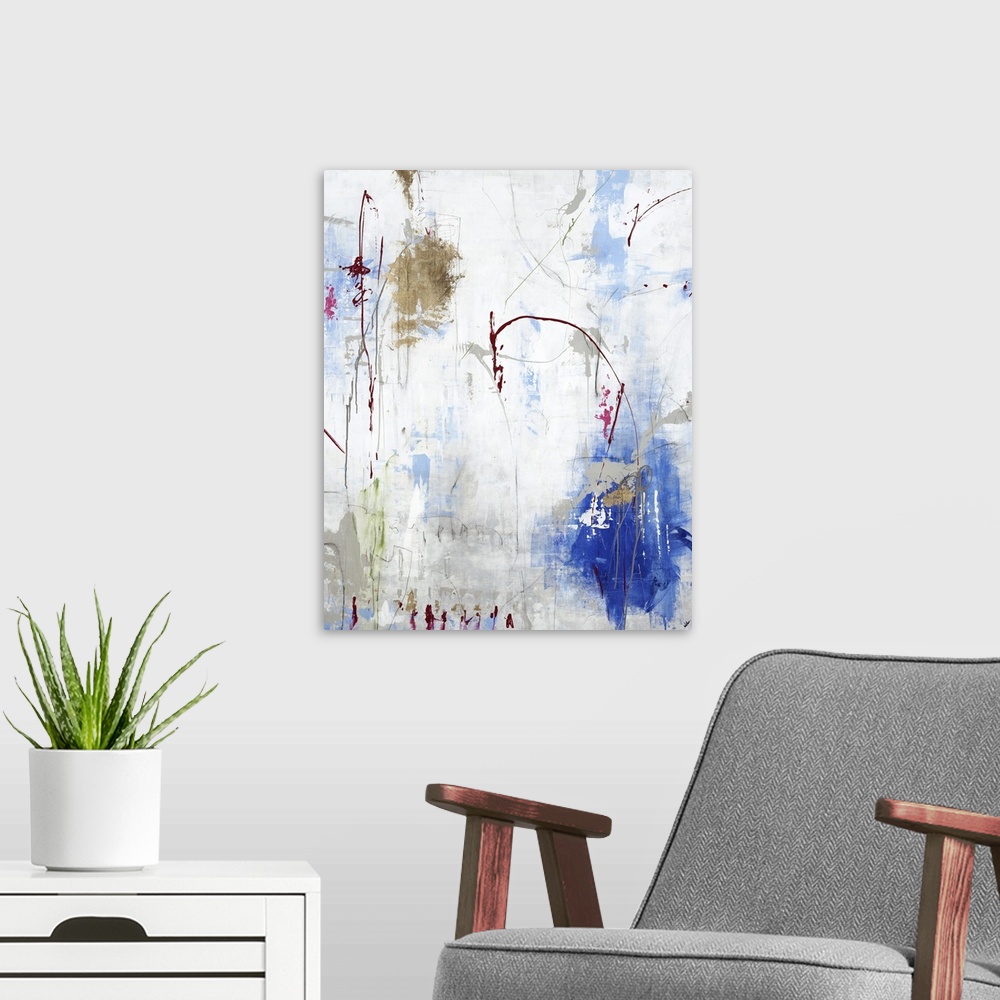 A modern room featuring Vertical abstract painting in gold and blue with textured drips of paint.