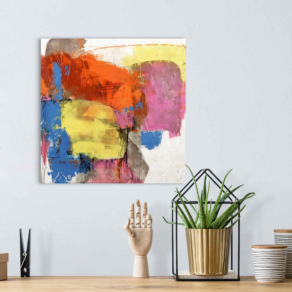 A bohemian room featuring Square abstract painting of vibrant colors in yellow, blue and orange.