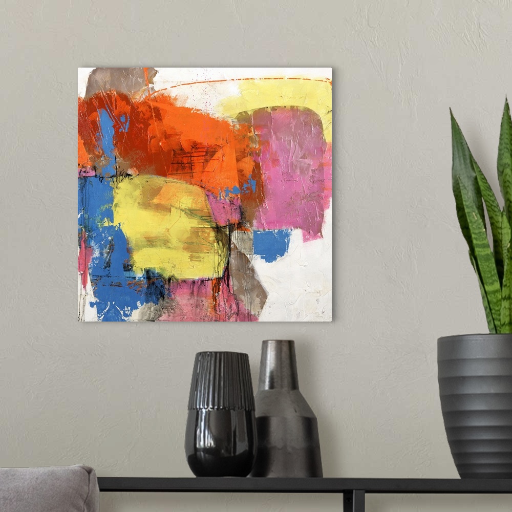 A modern room featuring Square abstract painting of vibrant colors in yellow, blue and orange.