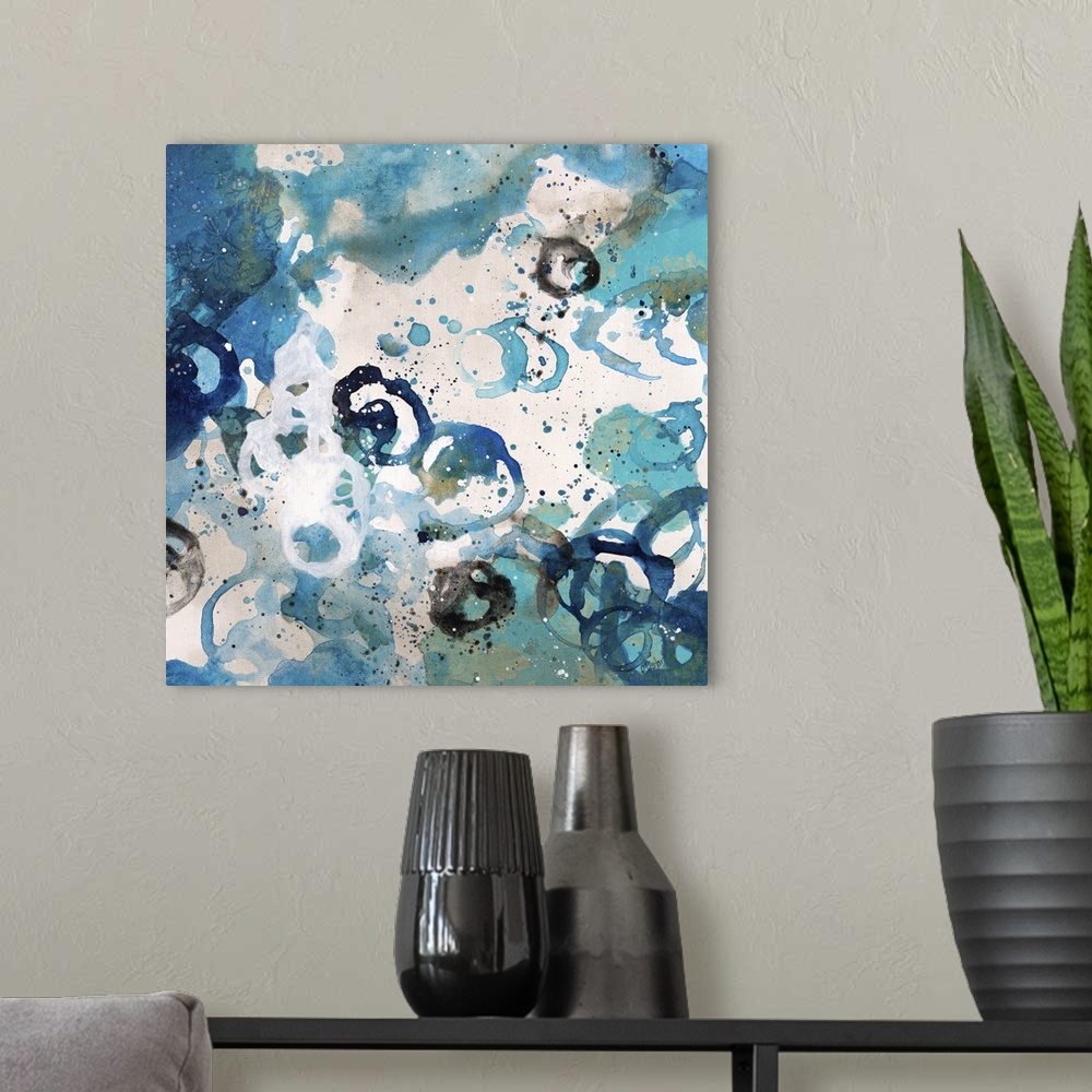 A modern room featuring Abstract painting using bright blue tones in splashes and splatters, almost looking like flowers.