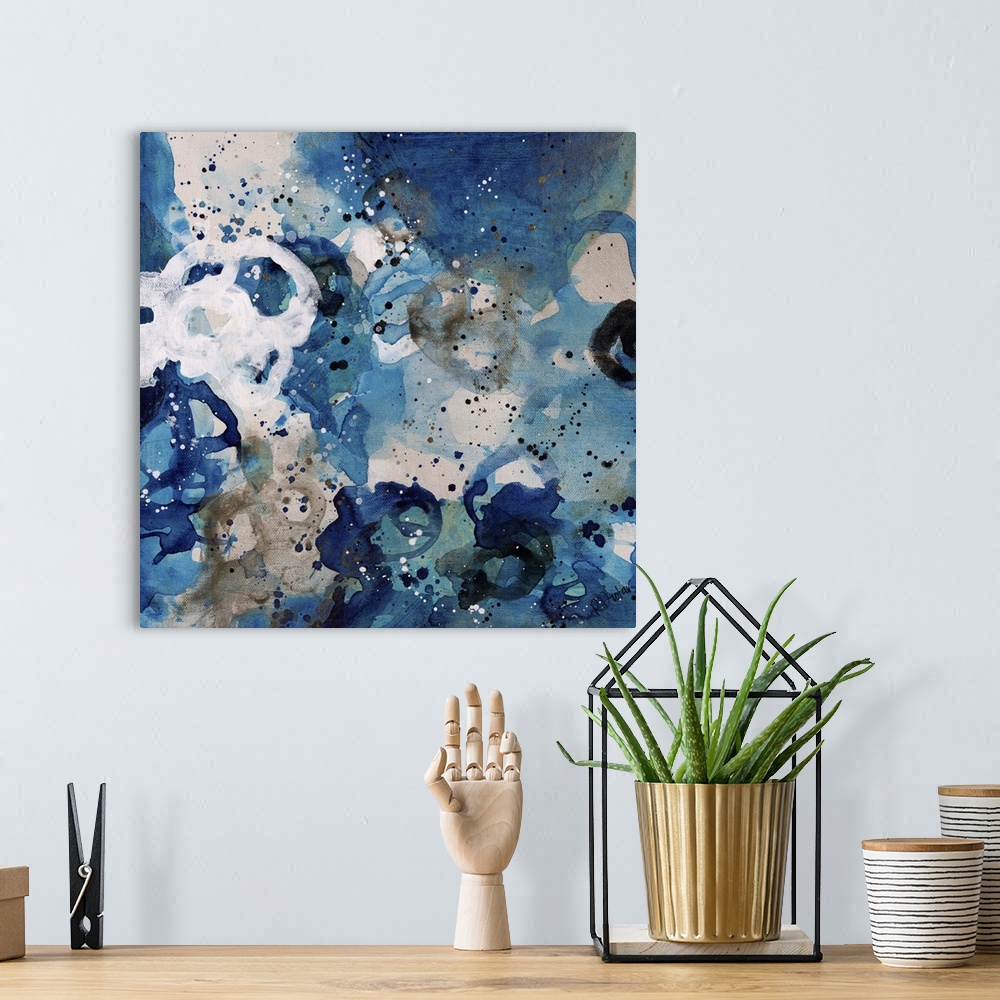 A bohemian room featuring Abstract painting using bright blue tones in splashes and splatters, almost looking like flowers.