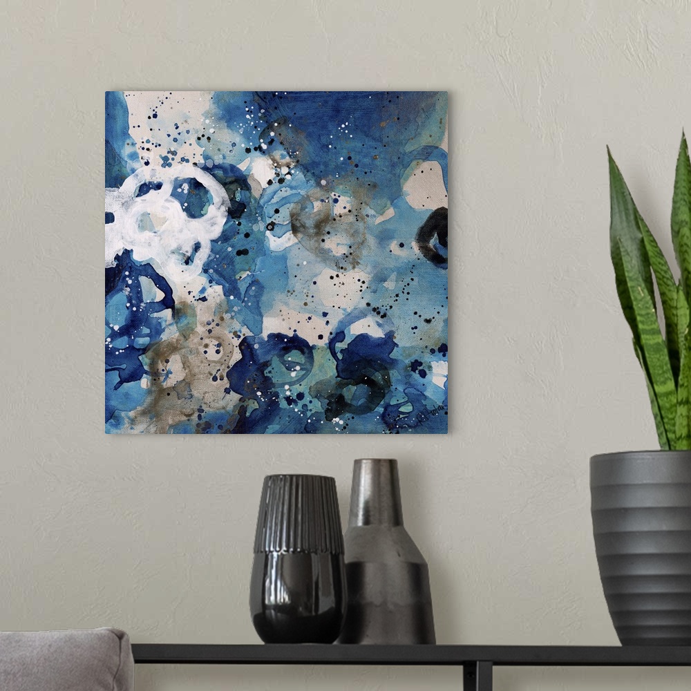 A modern room featuring Abstract painting using bright blue tones in splashes and splatters, almost looking like flowers.