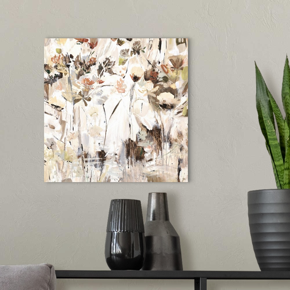 A modern room featuring Square abstract painting with neutral colors and pops of brighter hues resembling flowers.