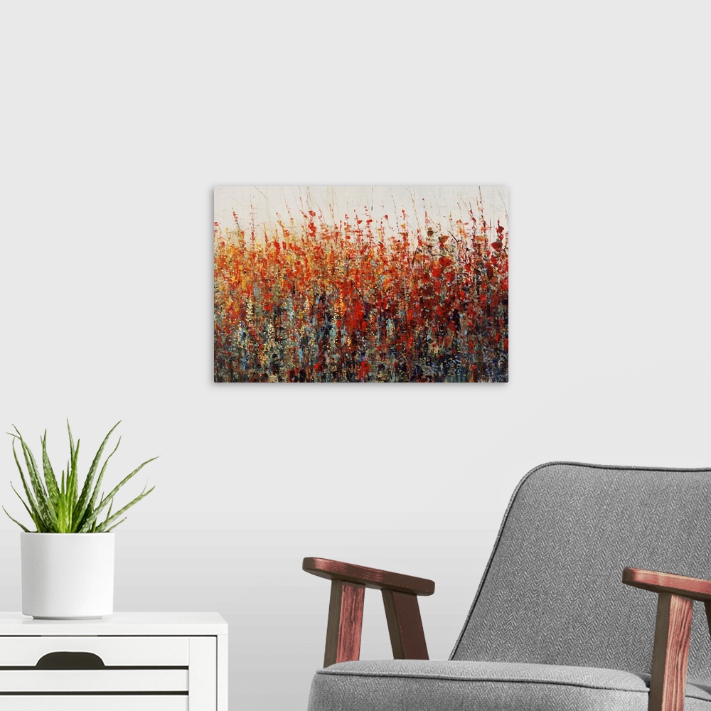 A modern room featuring Contemporary painting of vibrant warm toned flowers.