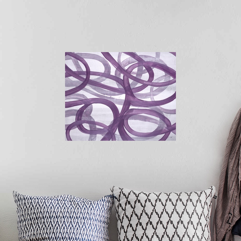 A bohemian room featuring A compelling painting of free flowing curved lines in purple.