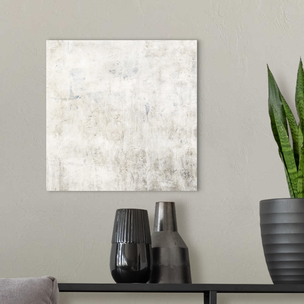 A modern room featuring Abstract painting of textured paint in light shades of white, tan and gray.
