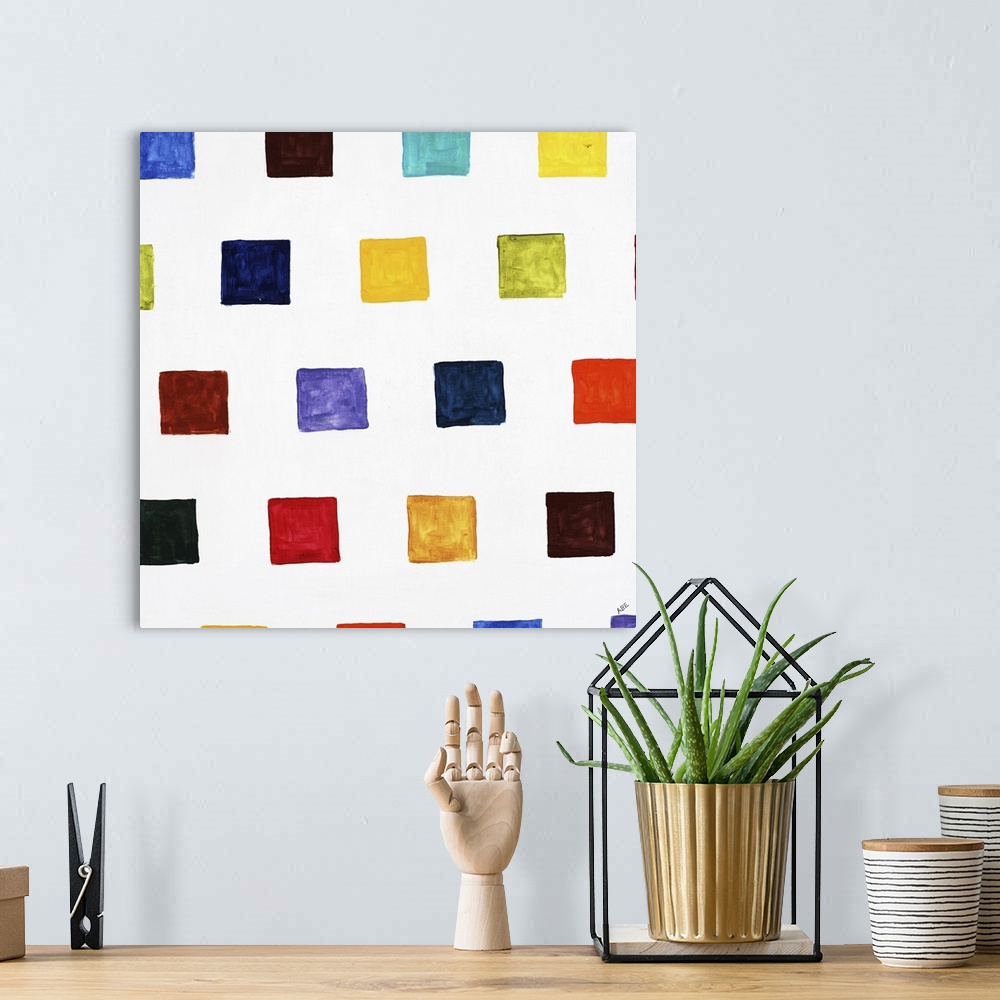A bohemian room featuring Square abstract art with different colored smaller squares in rows going up and down the canvas.