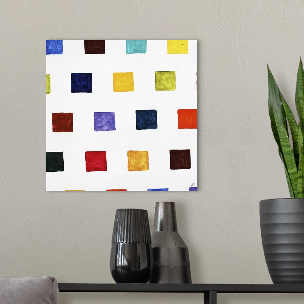 A modern room featuring Square abstract art with different colored smaller squares in rows going up and down the canvas.