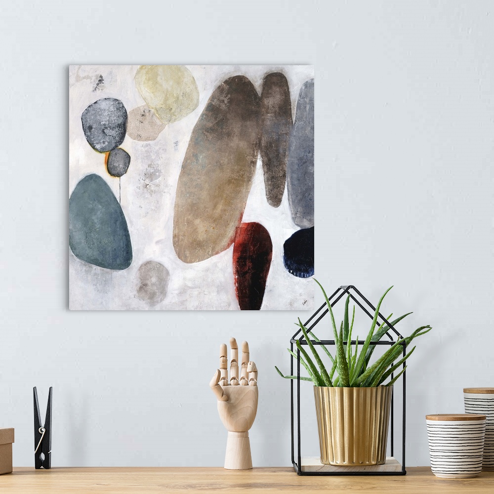 A bohemian room featuring Contemporary painting of a cluster of rocks in various sizes and colors, on a light background wi...