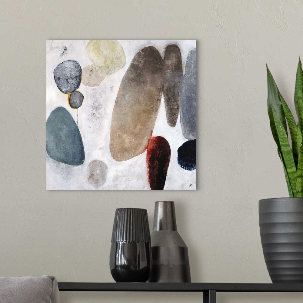A modern room featuring Contemporary painting of a cluster of rocks in various sizes and colors, on a light background wi...