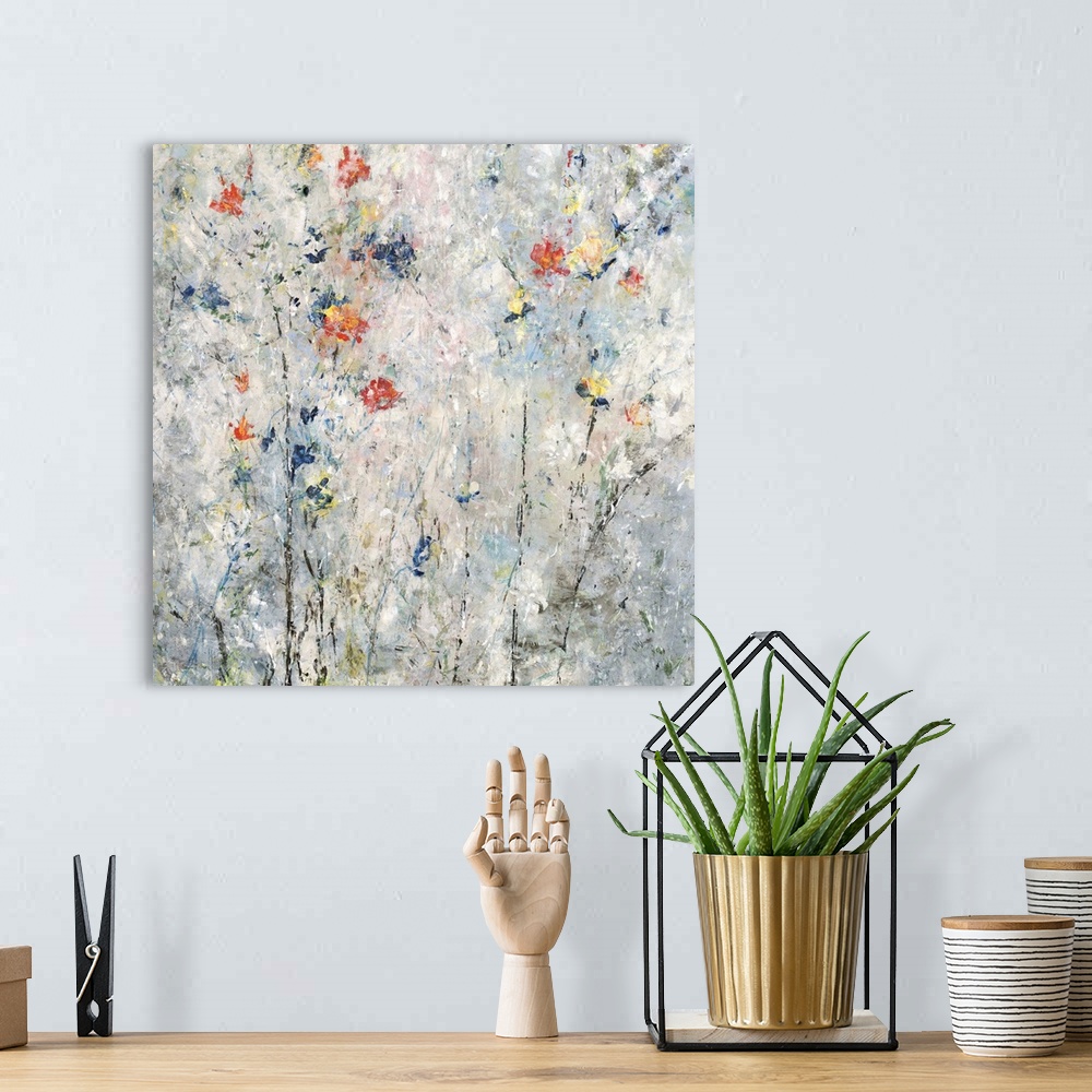 A bohemian room featuring Contemporary square painting with abstract flowers in blue, red, orange, and yellow hues on a gra...