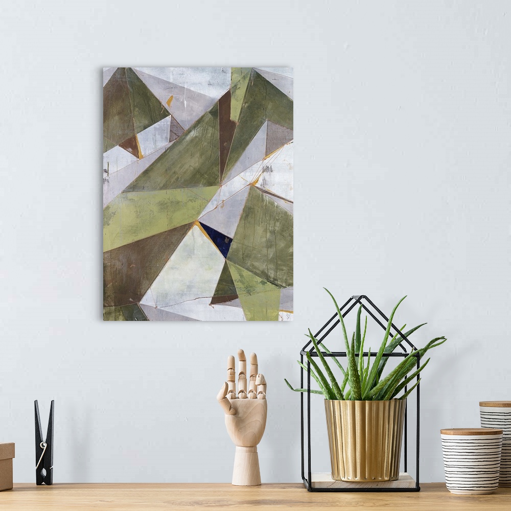A bohemian room featuring Abstract painting of overlapping triangular shapes in neutral and earth tones, randomly placed an...