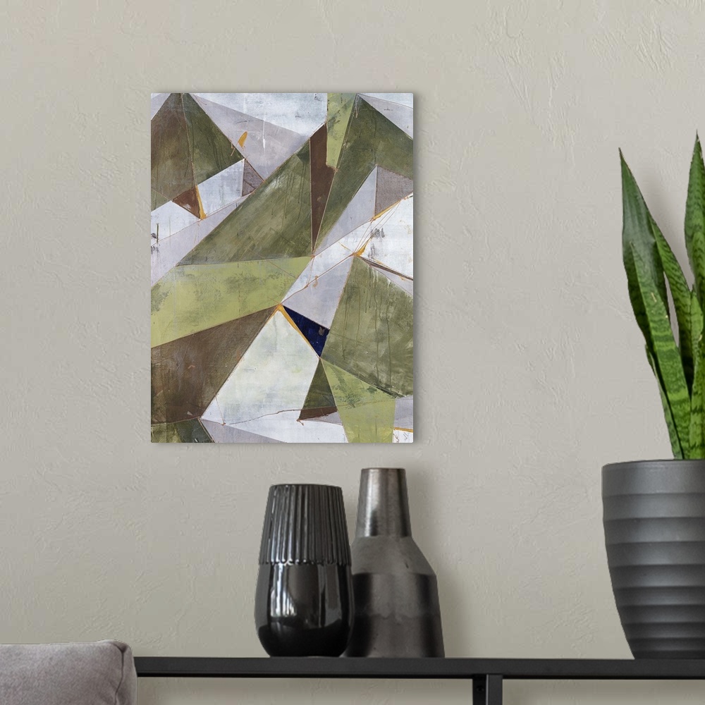A modern room featuring Abstract painting of overlapping triangular shapes in neutral and earth tones, randomly placed an...