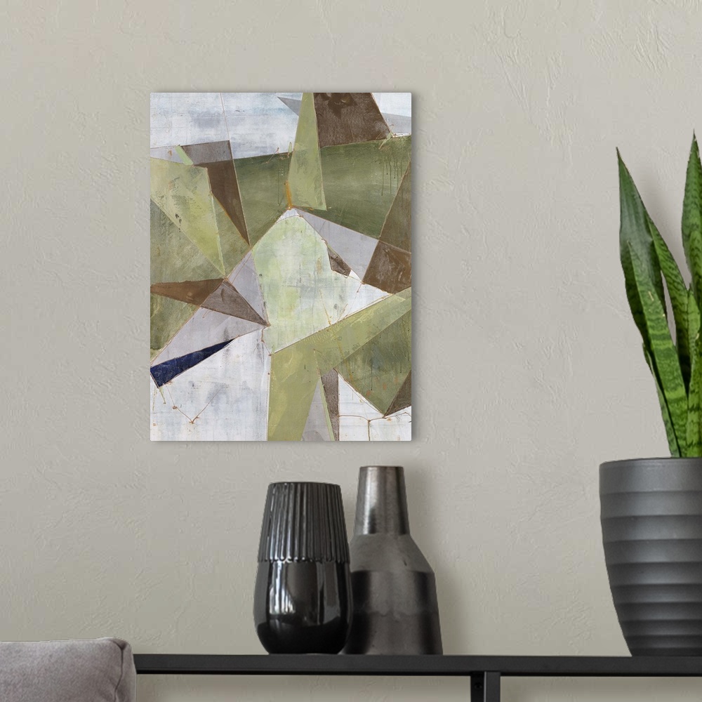A modern room featuring Abstract painting of overlapping triangular shapes in neutral and earth tones, randomly placed an...