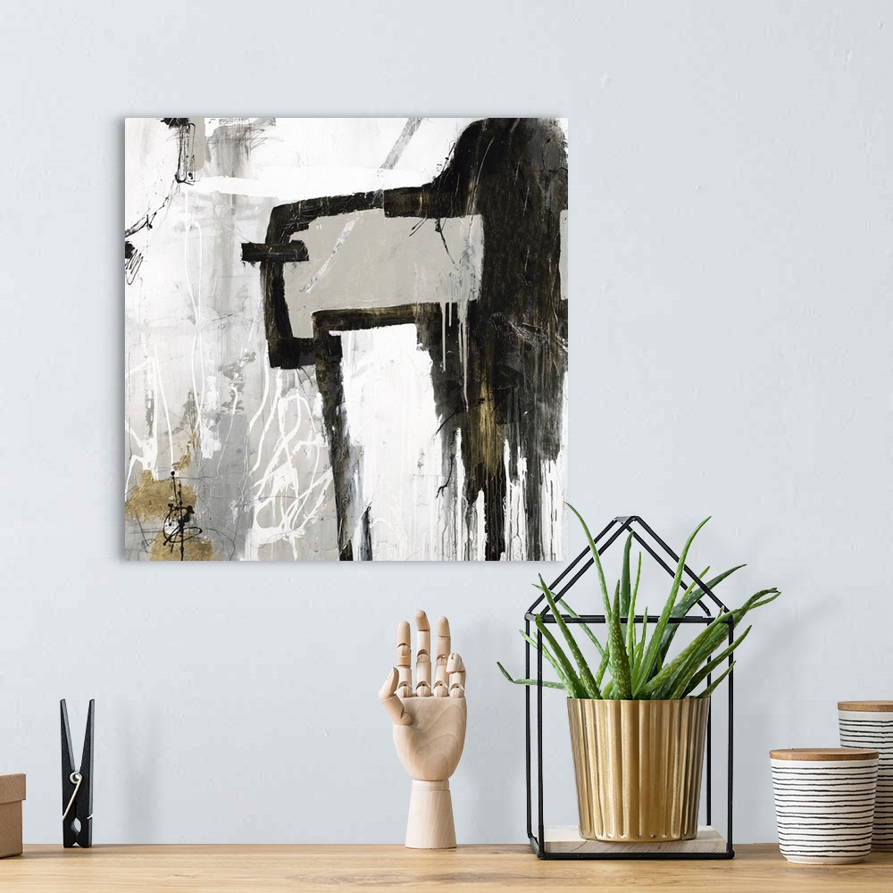 A bohemian room featuring Square abstract artwork in gray, white, black, and gold hues.