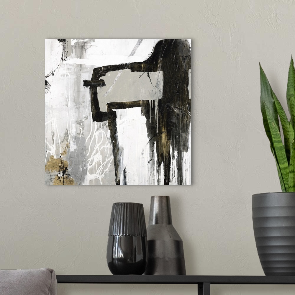 A modern room featuring Square abstract artwork in gray, white, black, and gold hues.
