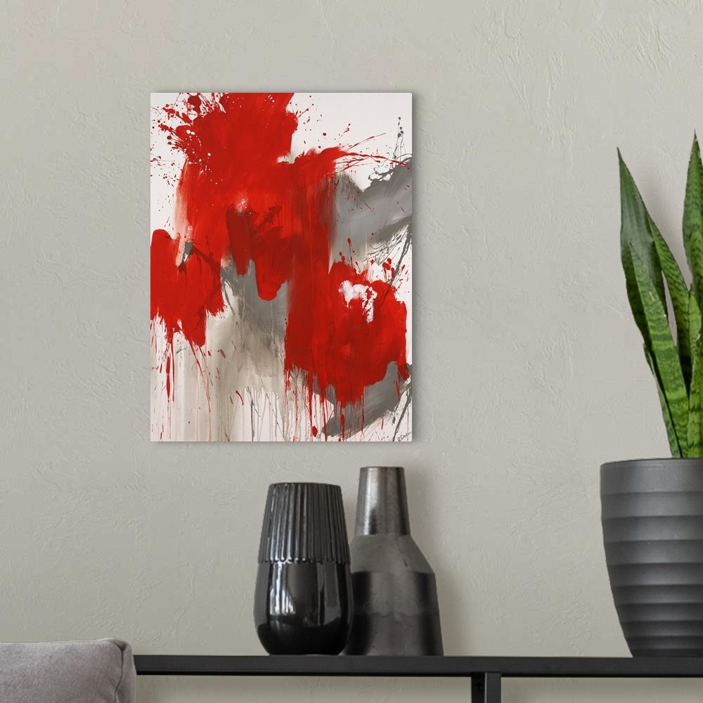 A modern room featuring Contemporary abstract painting of a giant red splash of paint smeared and splattered against a ne...