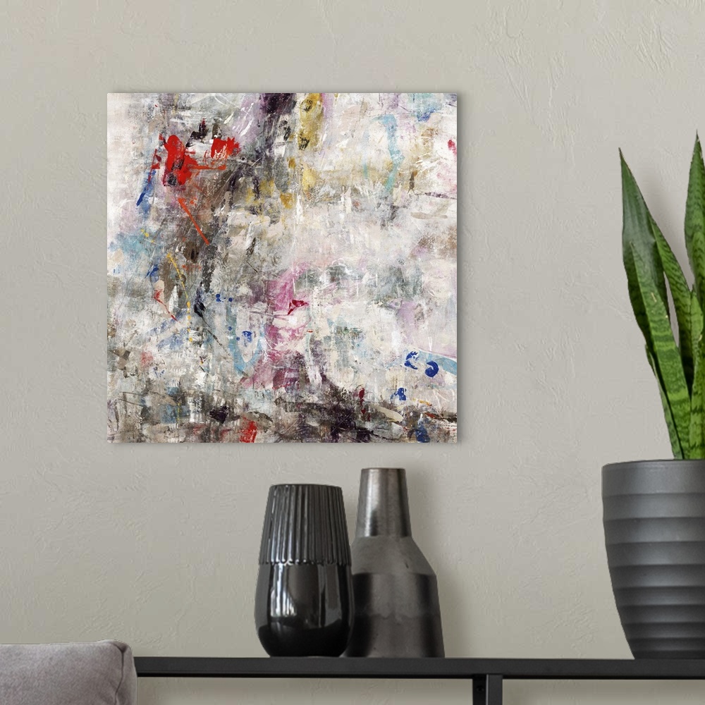 A modern room featuring Square abstract painting with busy strokes of color all over and softened with a white overlay.