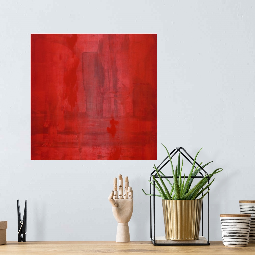 A bohemian room featuring Contemporary abstract painting of a dominating deep red covering the canvas, with a dark geometri...