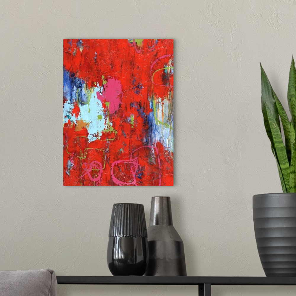 A modern room featuring Large abstract painting with bright red hues with pink and green lines on top and shades of blue ...