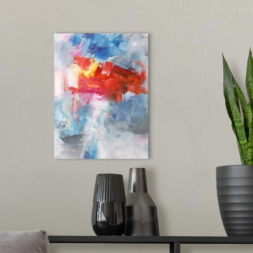 A modern room featuring Contemporary abstract painting using bright red tones over a mixture of blue tones over gray.