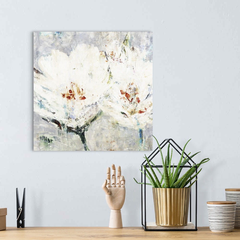 A bohemian room featuring Square artwork of two white flowers with orange accents in textured paint.