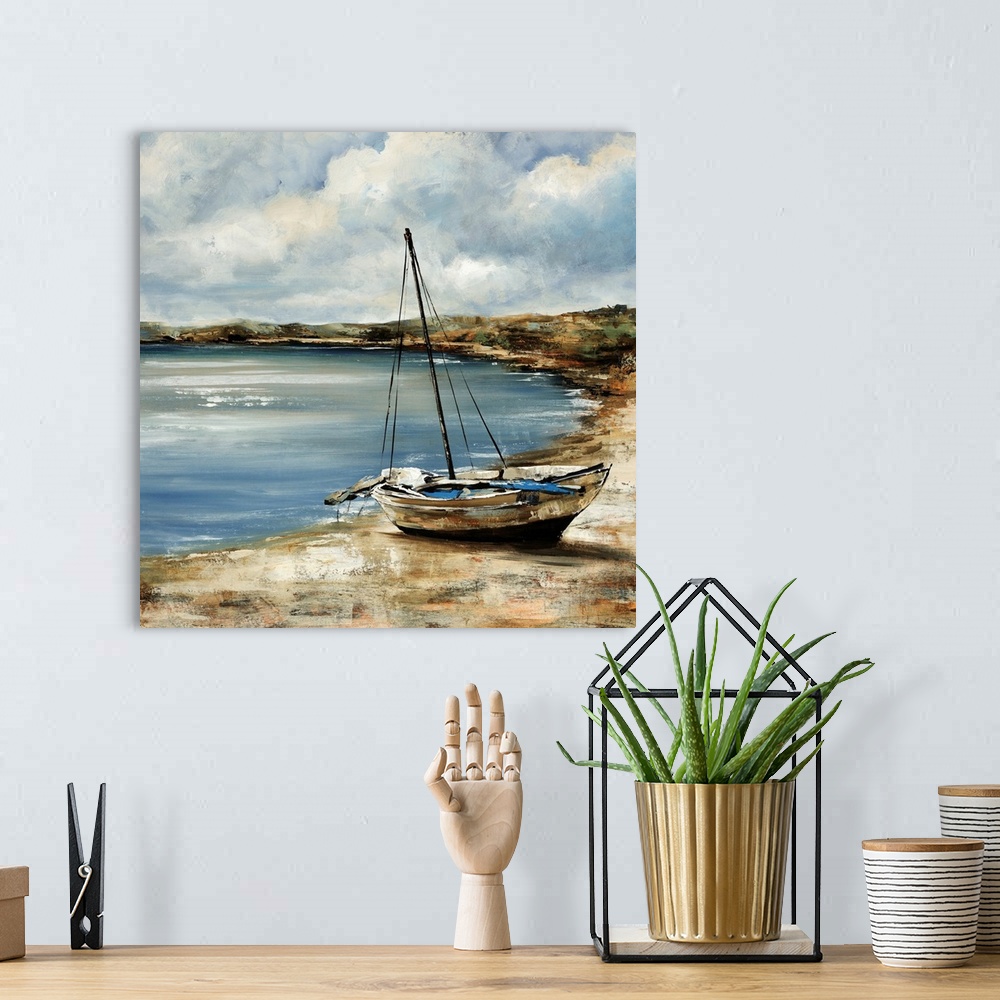 A bohemian room featuring Square painting of a sailboat sitting on the shore with water near it.