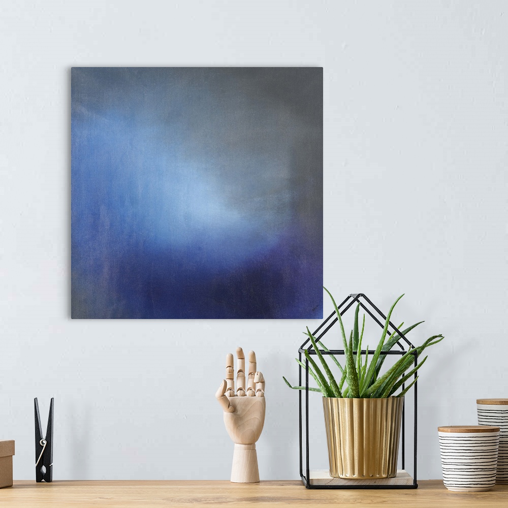 A bohemian room featuring Contemporary abstract painting using tones of blue to create depth.