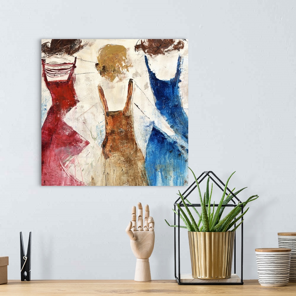A bohemian room featuring Contemporary painting of three women in colorful dresses with backs facing viewer.