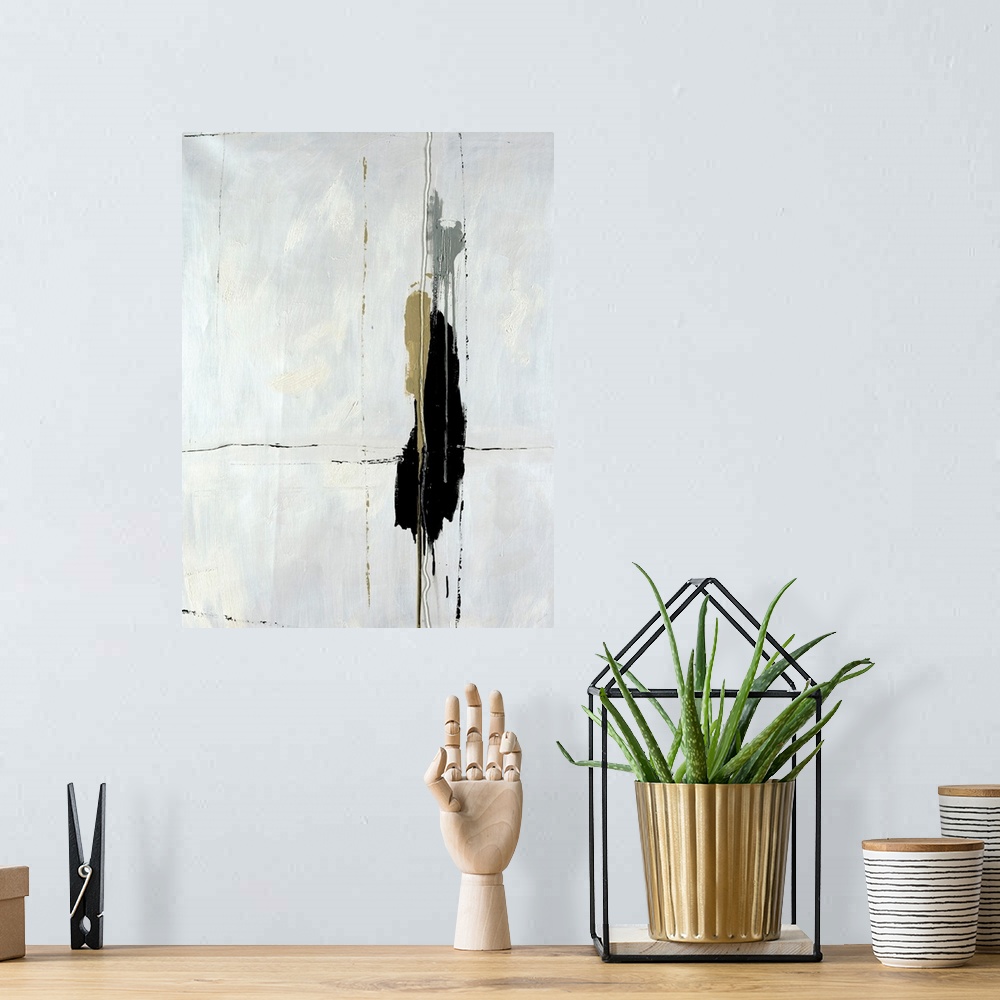 A bohemian room featuring High contrast abstract art piece of a dark paint blob on a cracking white background.