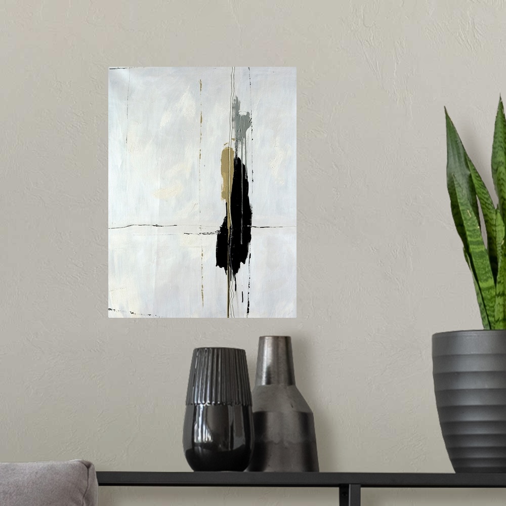 A modern room featuring High contrast abstract art piece of a dark paint blob on a cracking white background.