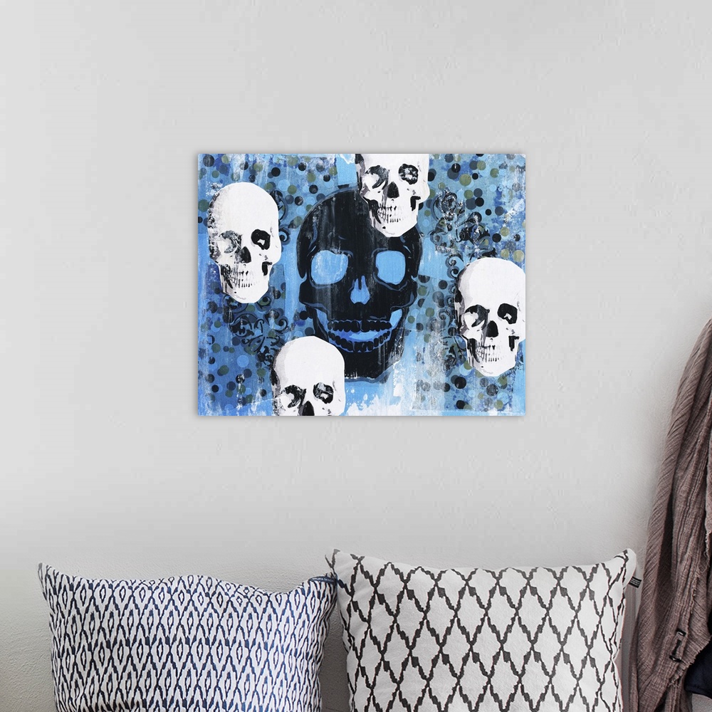 A bohemian room featuring Contemporary artwork with four white skulls circling one large black skull in the center with a b...