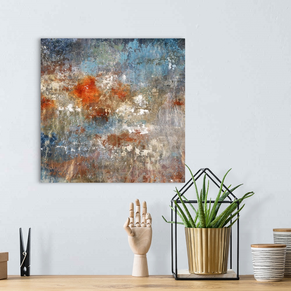 A bohemian room featuring Square abstract painting with textured color in shades of gold, bronze, blue, white, gray, and br...