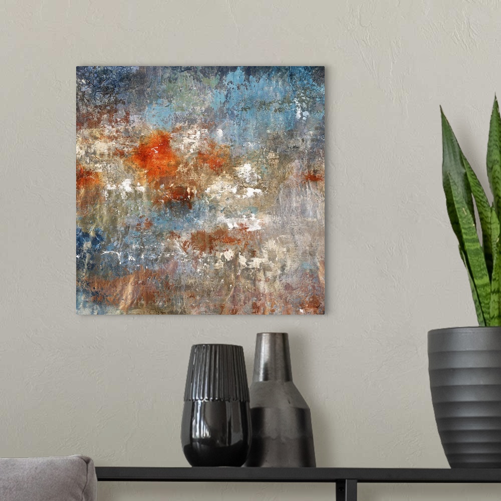 A modern room featuring Square abstract painting with textured color in shades of gold, bronze, blue, white, gray, and br...