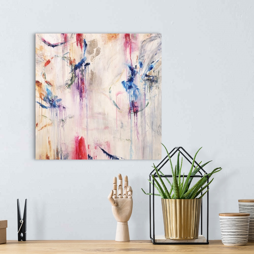 A bohemian room featuring Square abstract painting with bright pops of color and faint circular figures with paint dripping...