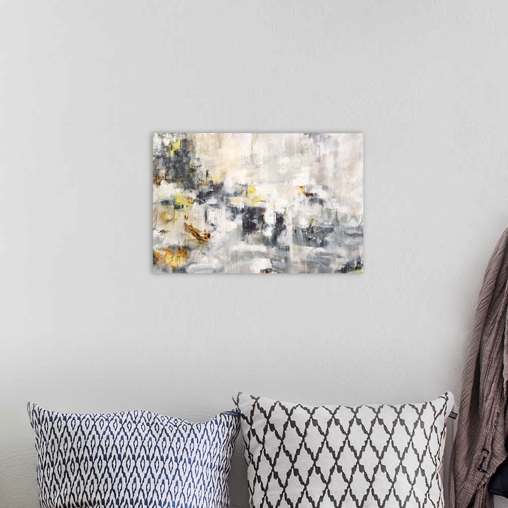 A bohemian room featuring Large abstract painting in white, gray, black, and yellow hues with paint drips.