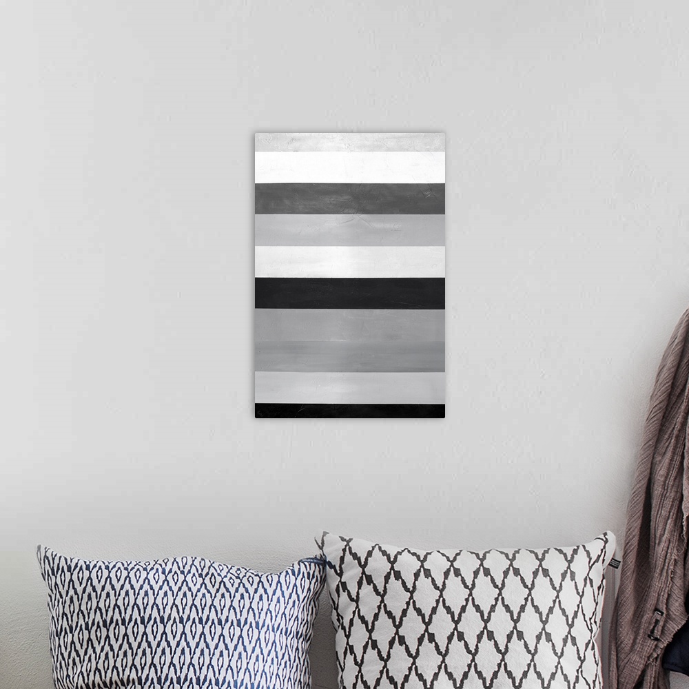 A bohemian room featuring Large abstract painting with gray, white, and black horizontal bands stacked on top of each other...
