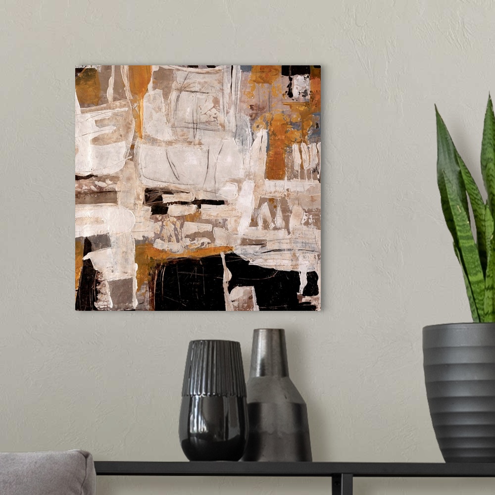 A modern room featuring Abstract artwork that is mostly off white with chunks of black and tan thrown in.