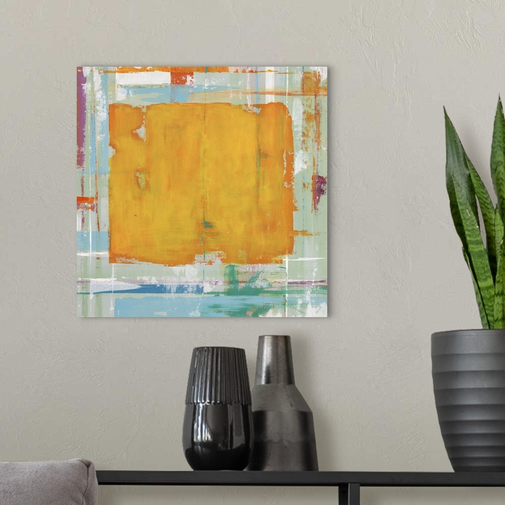 A modern room featuring Abstract painting with an orange rectangle in the center of the image against blue and yellow col...