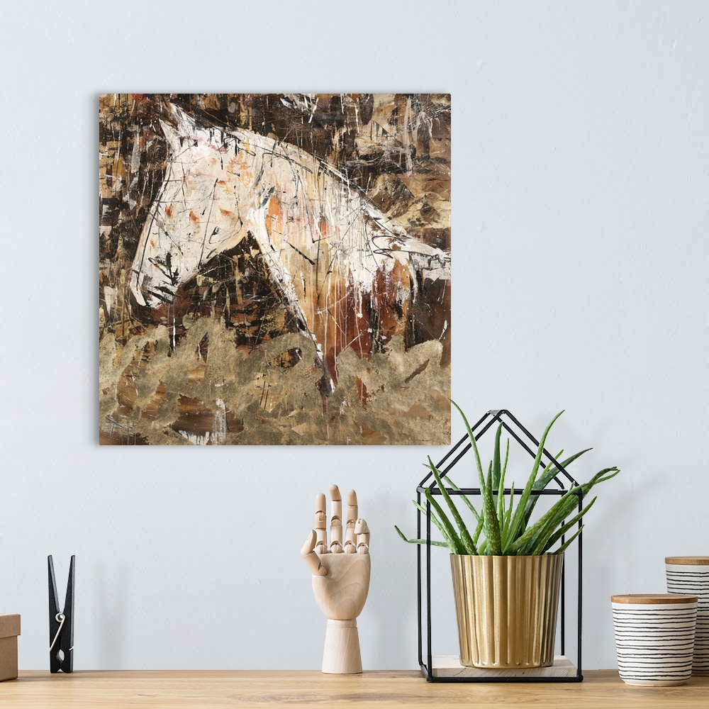 A bohemian room featuring Square abstract painting of a horse silhouette in shades of brown, gold, orange, and white.