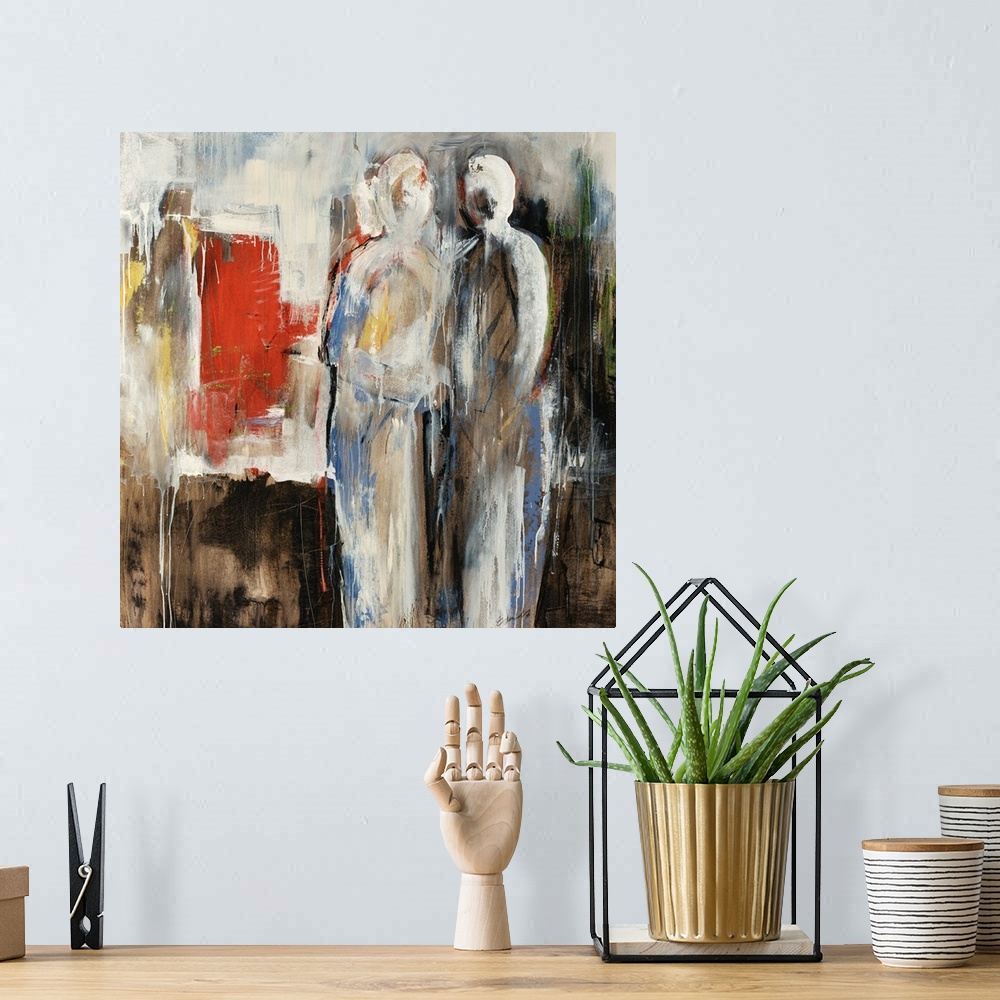 A bohemian room featuring An abstract painting of two figures in neutral colors with pops of red.